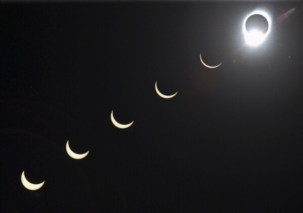 FILE - The progression of a total solar eclipse is seen in a multiple exposure photograph taken in 5-minute intervals, with the moon passing in front of the sun above Siem Reap in northwestern Cambodia, 225 kilometers (140 miles) from Phnom Penh, on Tuesday, Oct. 24, 1995. (AP Photo/Richard Vogel, File)